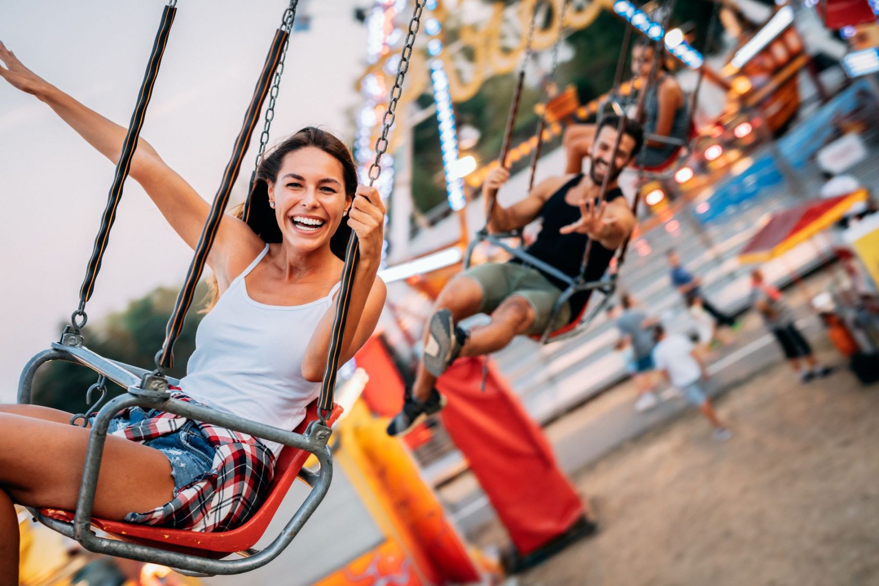 woman enjoying swing ride at carnival